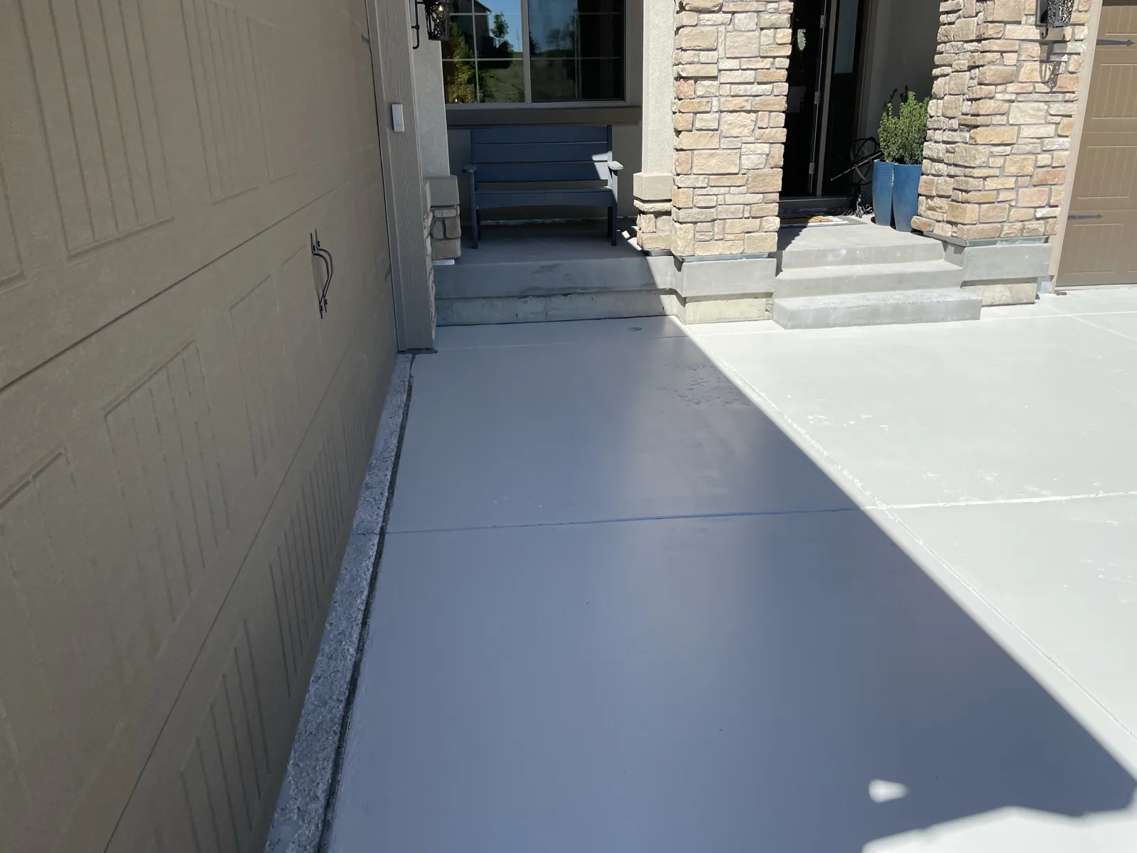 New concrete walkway connecting house to garage
