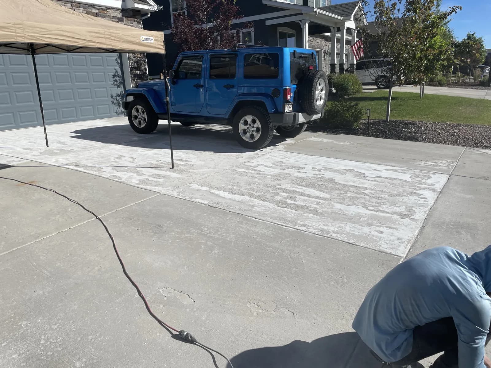 Driveway pressure washing and sealing in progress