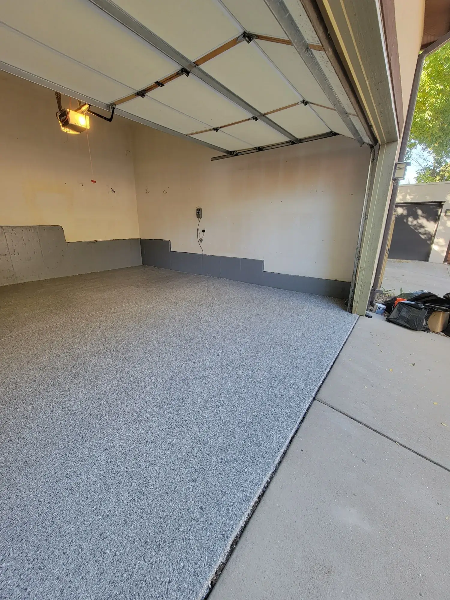 Completed epoxy garage floor coating with the door open